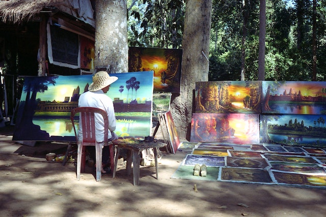 A man painting on the street.